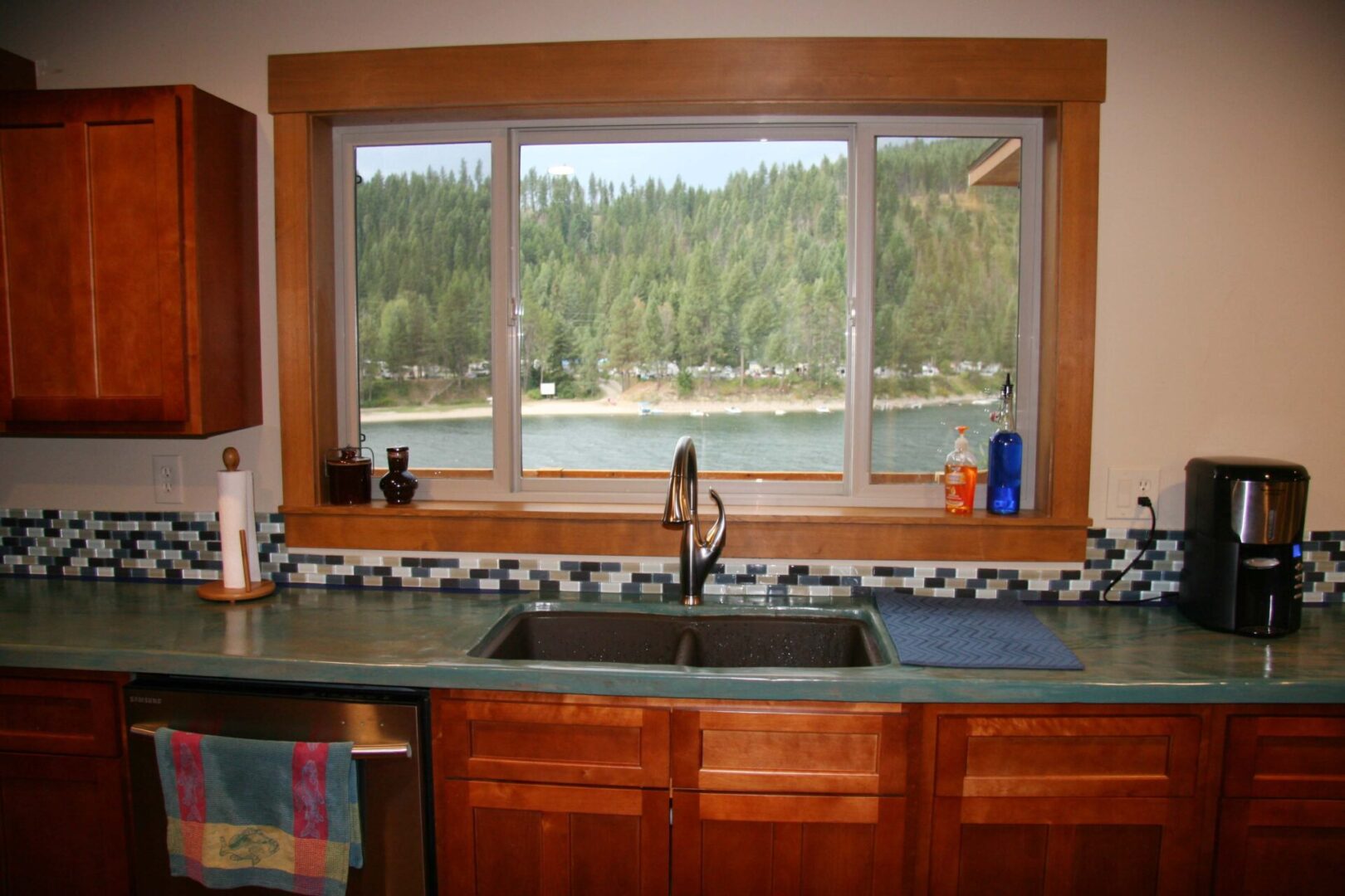 Wooden kitchen sink cabinet with a window overlooking a natural view