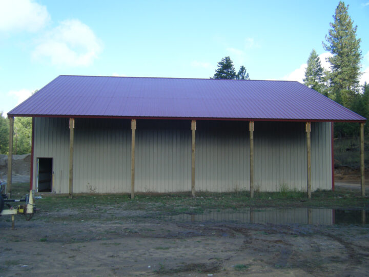 Side view of a workshop with extended roofs supported by poles